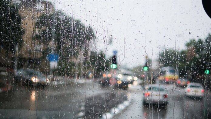 Israel rain view to street through rain-specked window